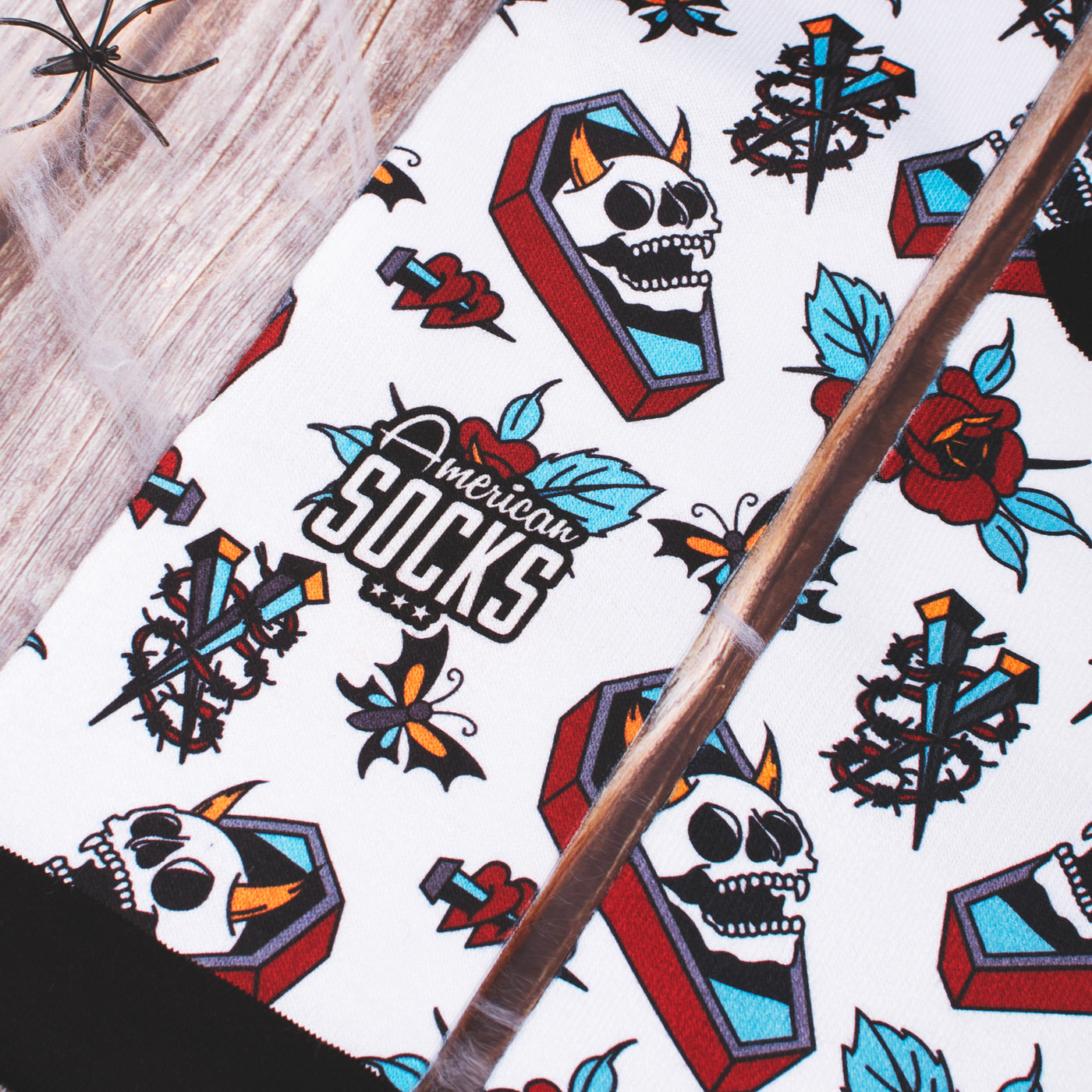 Close up of american socks grave with skull and flowery roses blades and butterflies