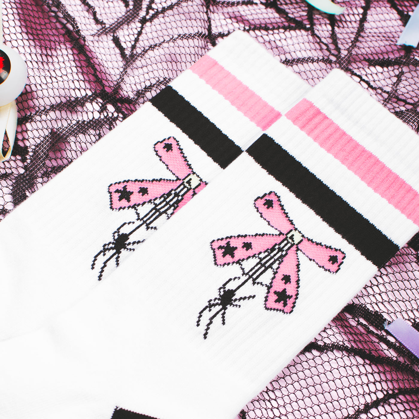 Close up of cute crew socks with pink ribbon and tiny spider design by american socks 