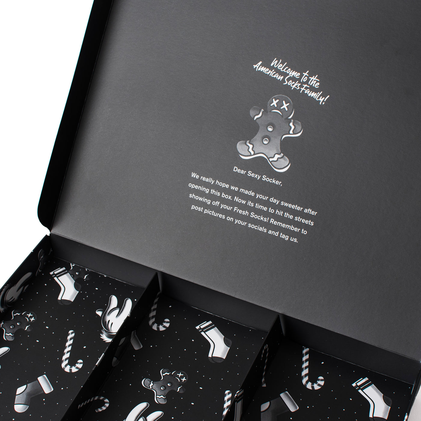 Close up of the empty interior of Xmas giftbox with welcoming quote by american socks