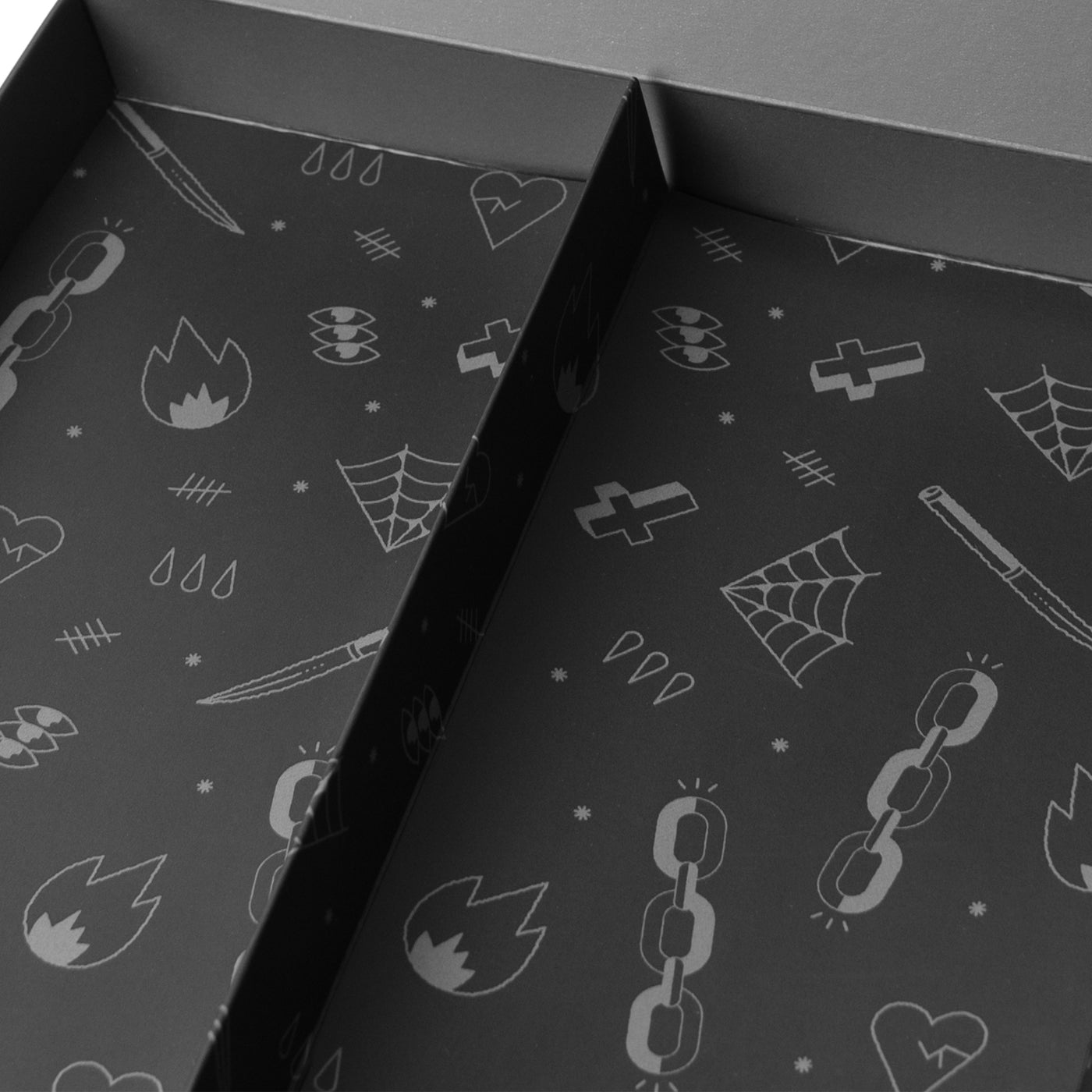 Close up of empty interior of black tattoo inspired doodle giftbox by american socks