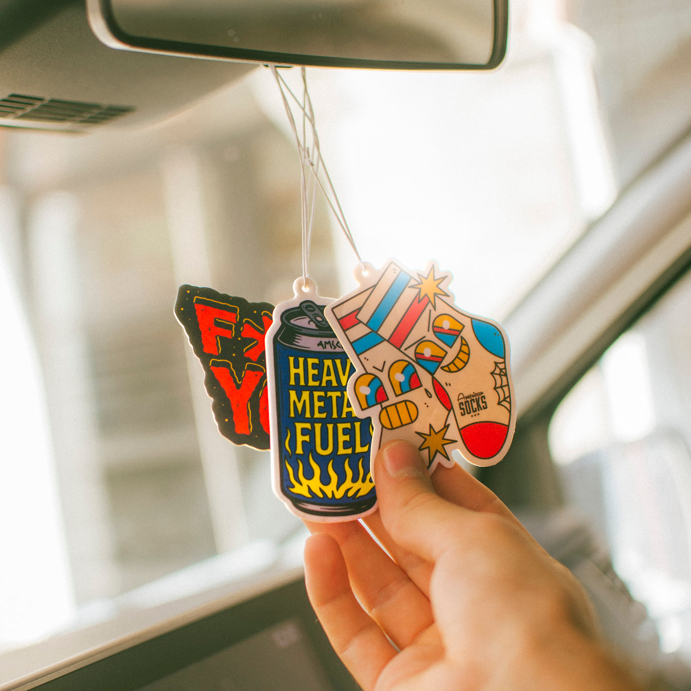Fun rock air fresheners hanging from car mirror american socks 