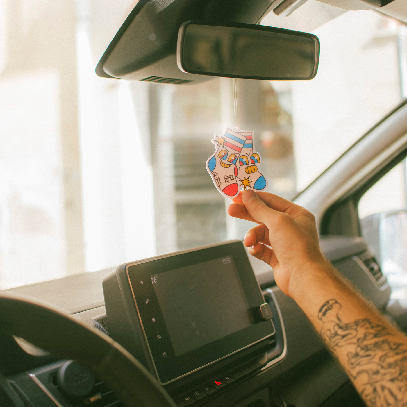 Funky air freshener with edgy socks design hanging form car rearview american socks
