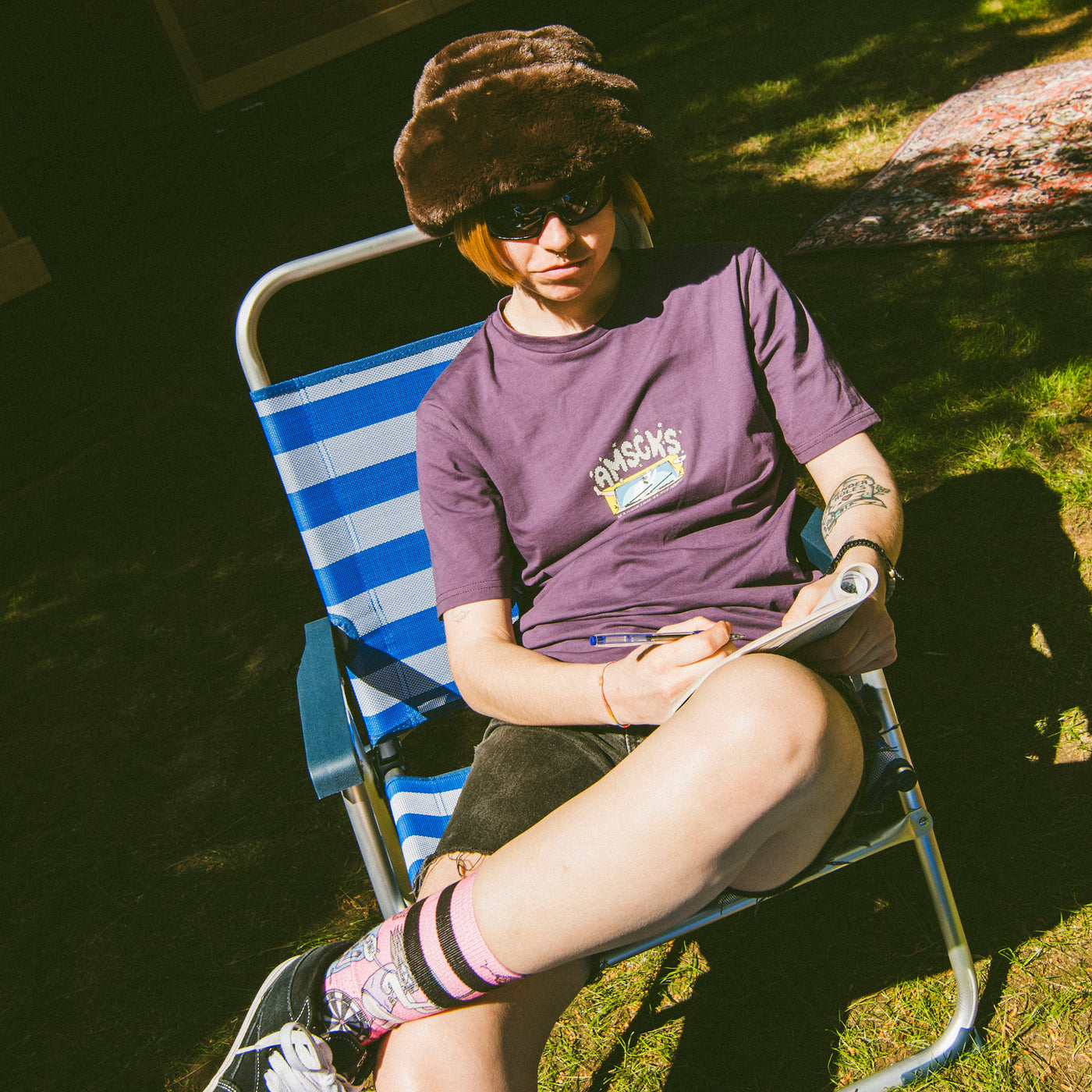 Person sitting on a beach chair wearing cool alternative clothes american socks