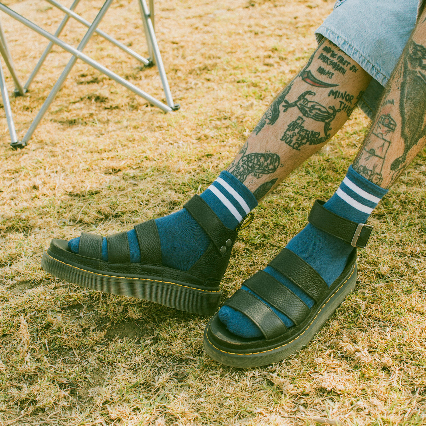 Blue trainer socks with two white stripes worn by a man outdoors american socks 